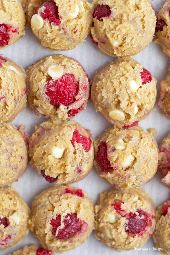 white chocolate raspberry cookie dough on a parchment lined cookie sheet