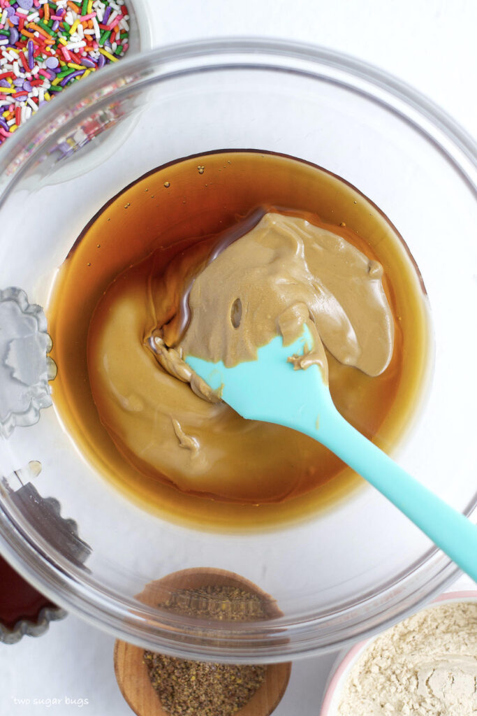 sunflower seed butter and maple syrup in a bowl with a spatula