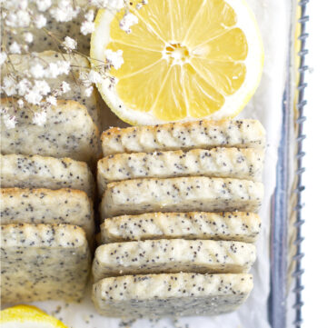 overhead look at lemon poppy seed cookies on a serving tray with a lemon slice