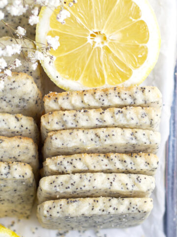 overhead look at lemon poppy seed cookies on a serving tray with a lemon slice