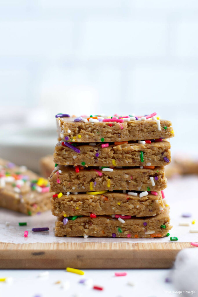 stack of homemade birthday cake flavor protein bars on a cutting board