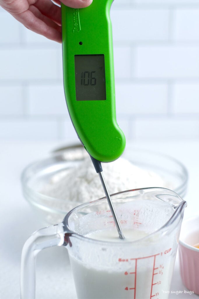 hand holding a thermometer in warm buttermilk
