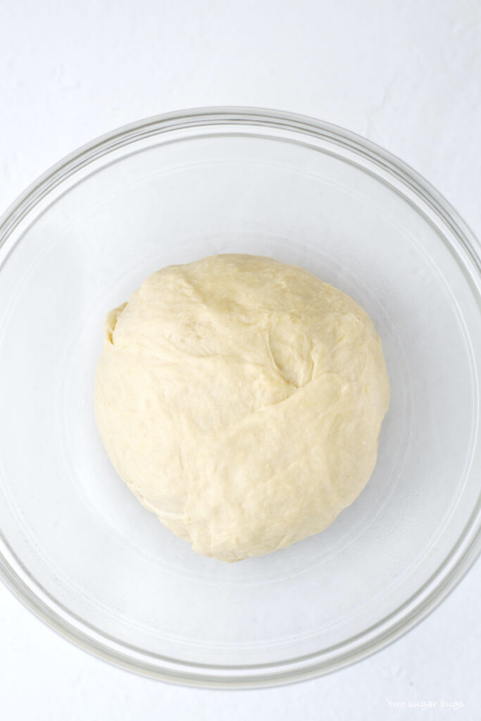 the cinnamon roll dough in a bowl before the first quick rise