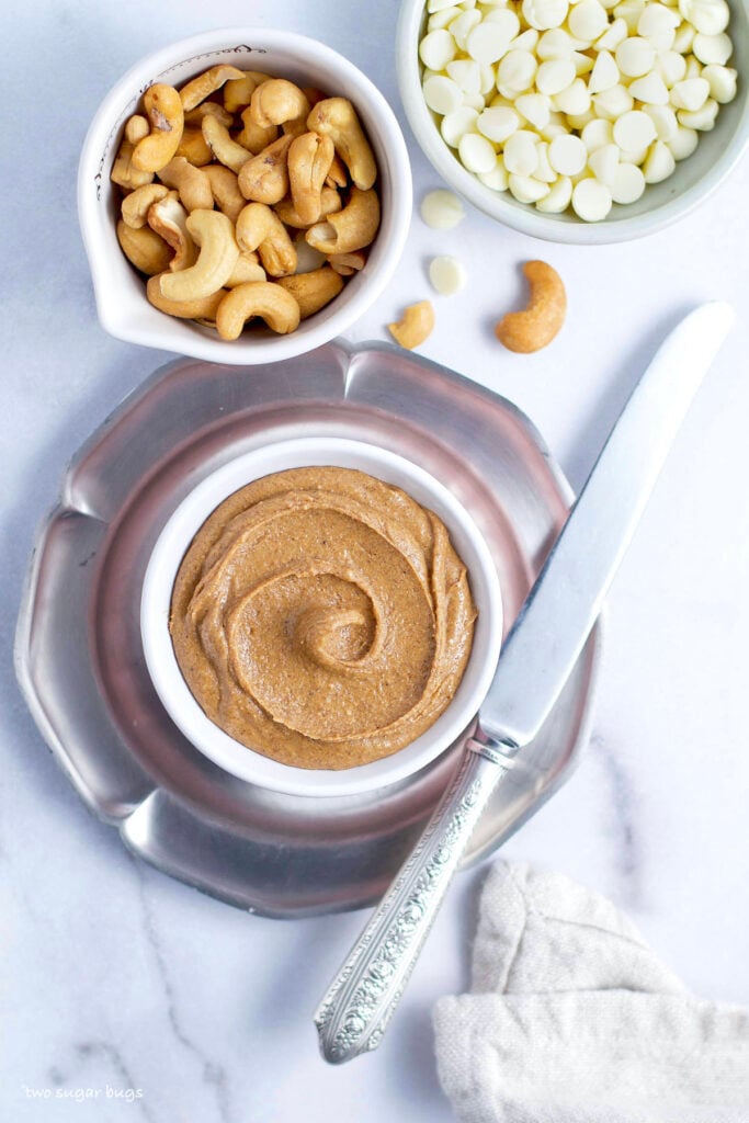 white chocolate chips, cashews and a bowl of gluten free cookie butter