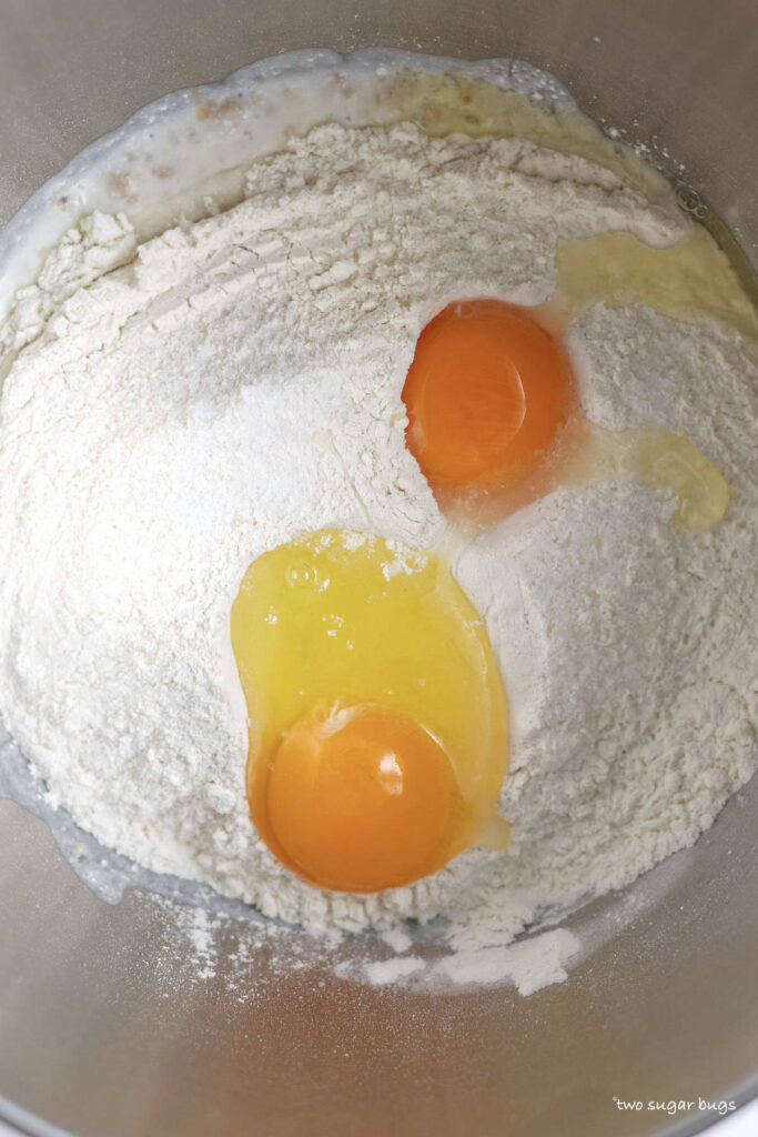 eggs on top of flour in a mixing bowl