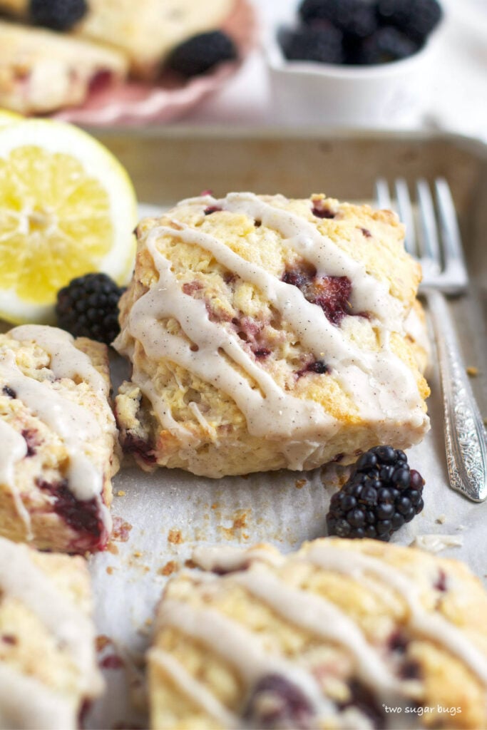 blackberry lemon scones on a tray with a fork