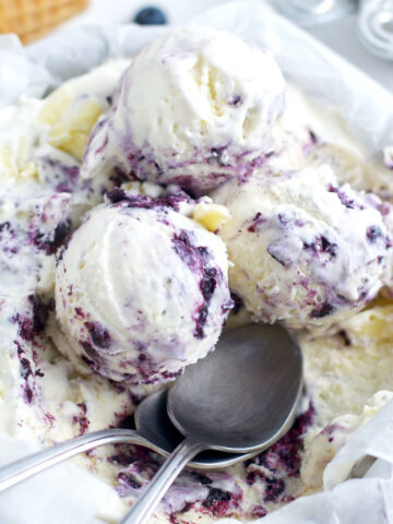 white chocolate roasted blueberry ice cream with two spoons