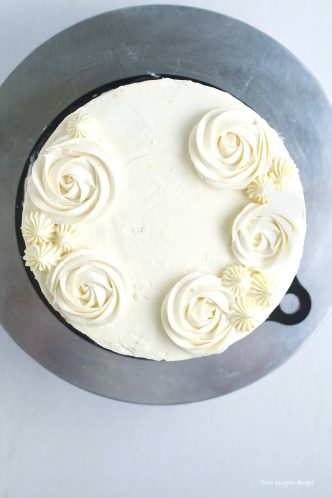 rosettes piped on top of lemon white chocolate cake