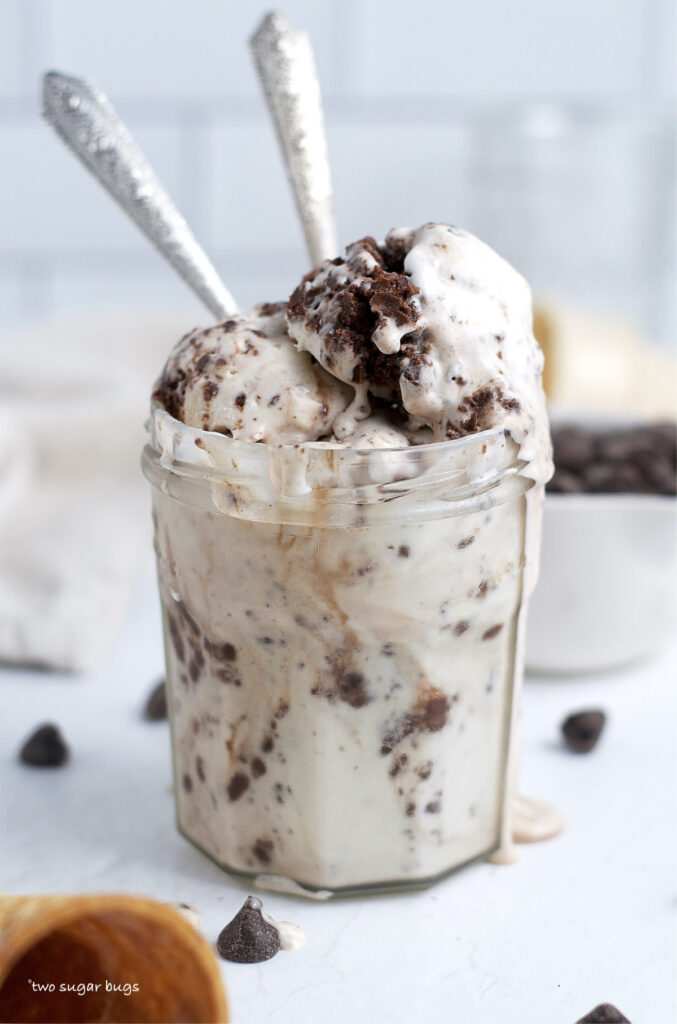 brownie batter ice cream in a glass jar with two spoons