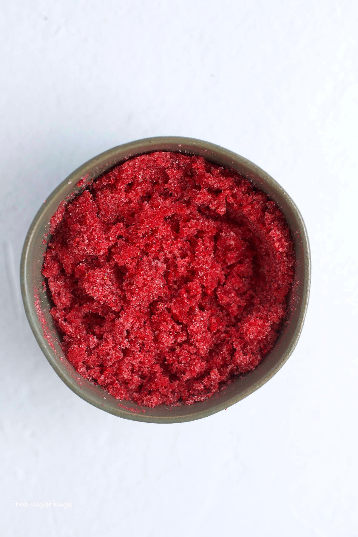 ground dried strawberries and sugar mixed in a bowl