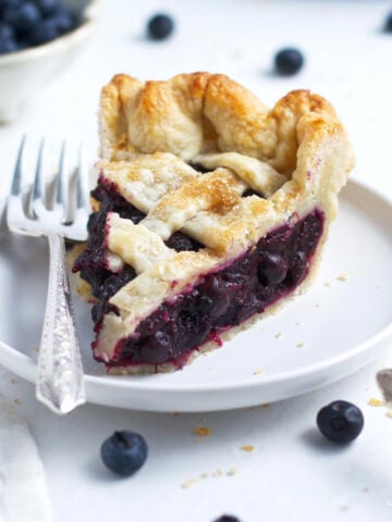 slice of frozen blueberry pie on a plate with a fork