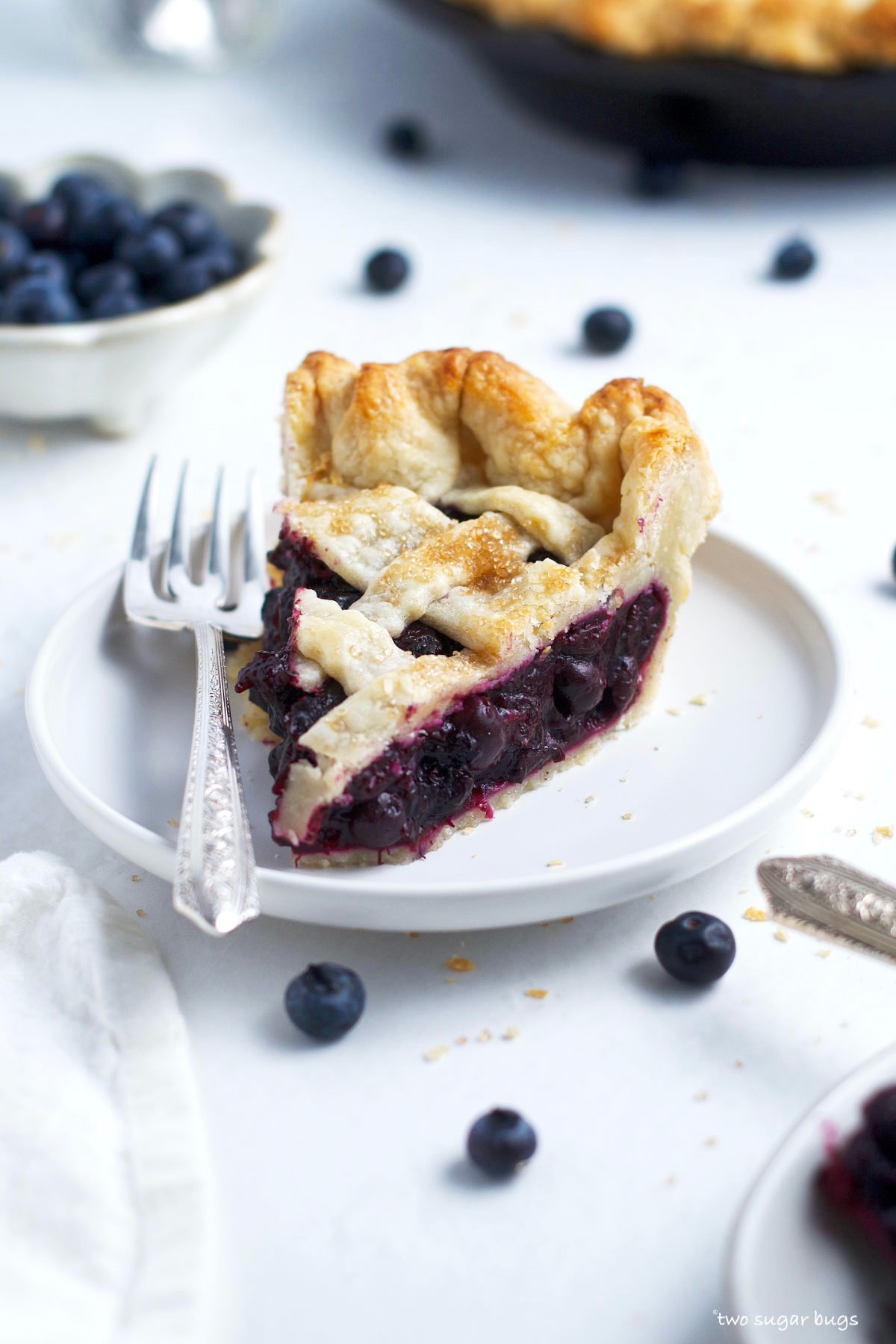 slice of frozen blueberry pie on a plate with a fork