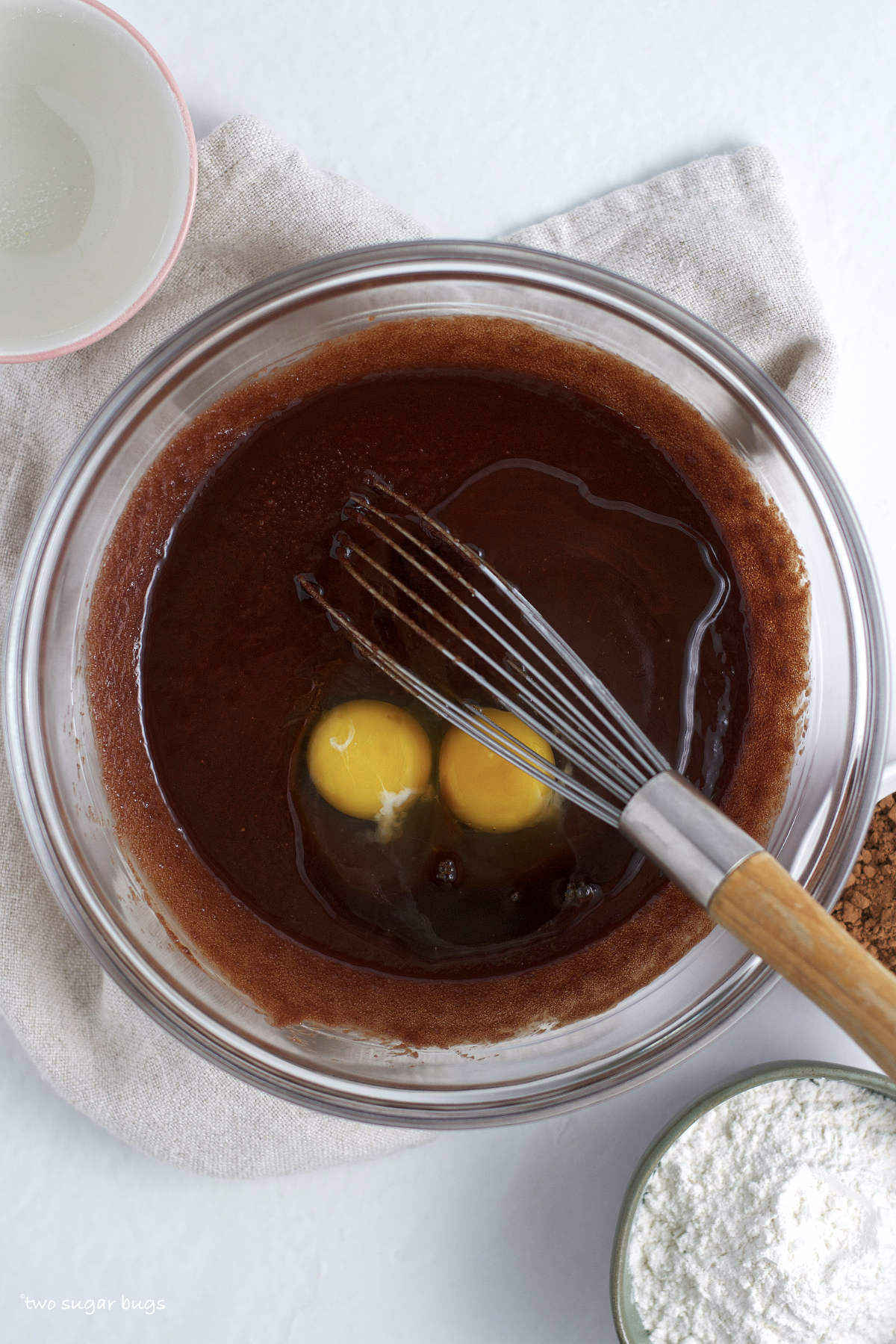 eggs added to melted chocolate, butter and sugar in a bowl