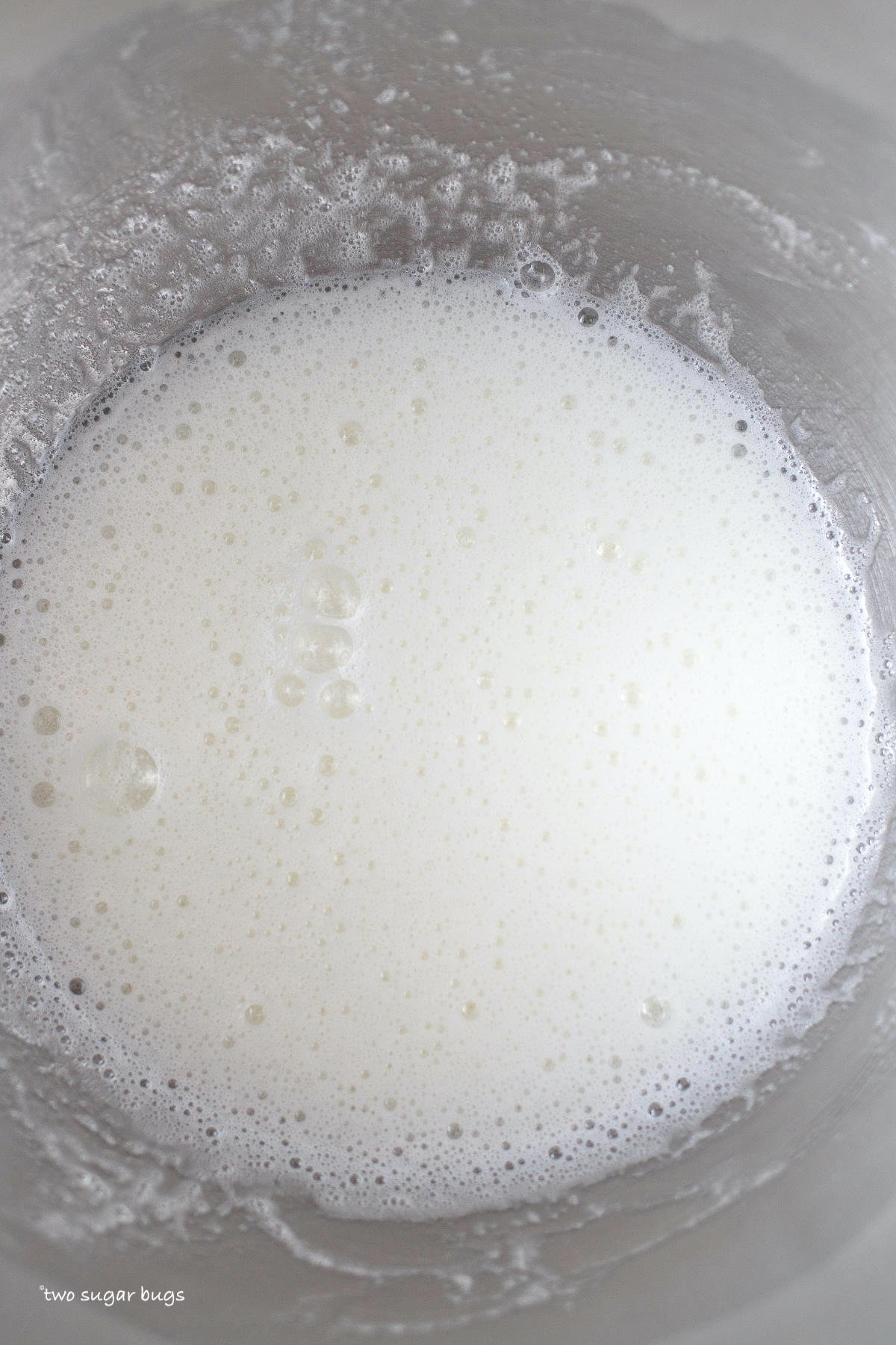 egg whites and sugar dissolved in a mixing bowl