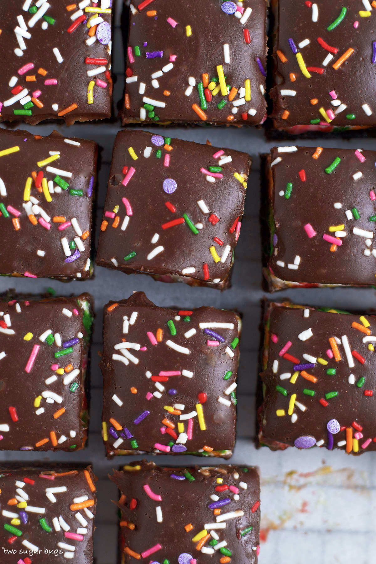 chocolate ganache with sprinkles on top of brownies