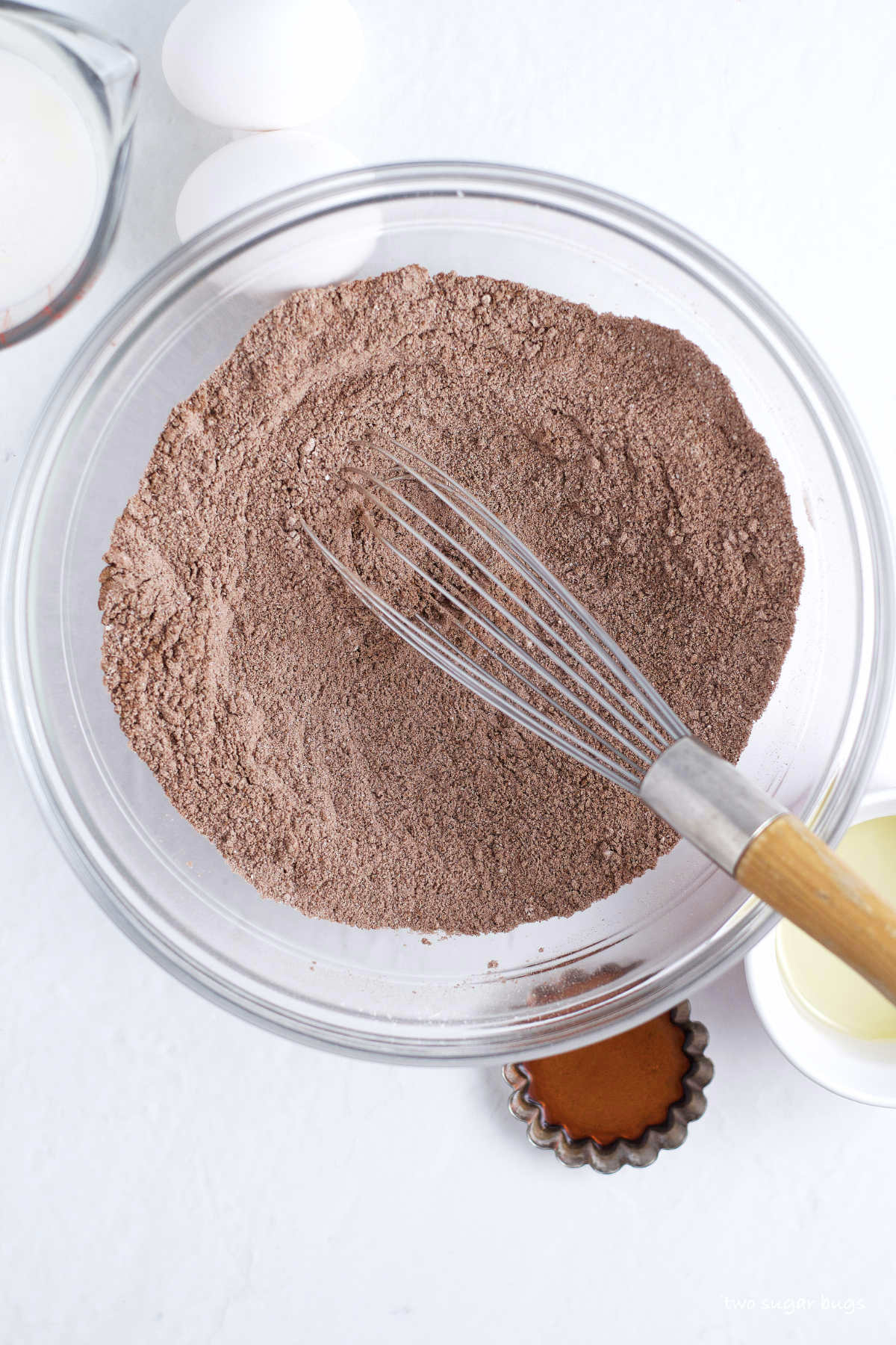 dry chocolate cupcake ingredients in a bowl with a whisk