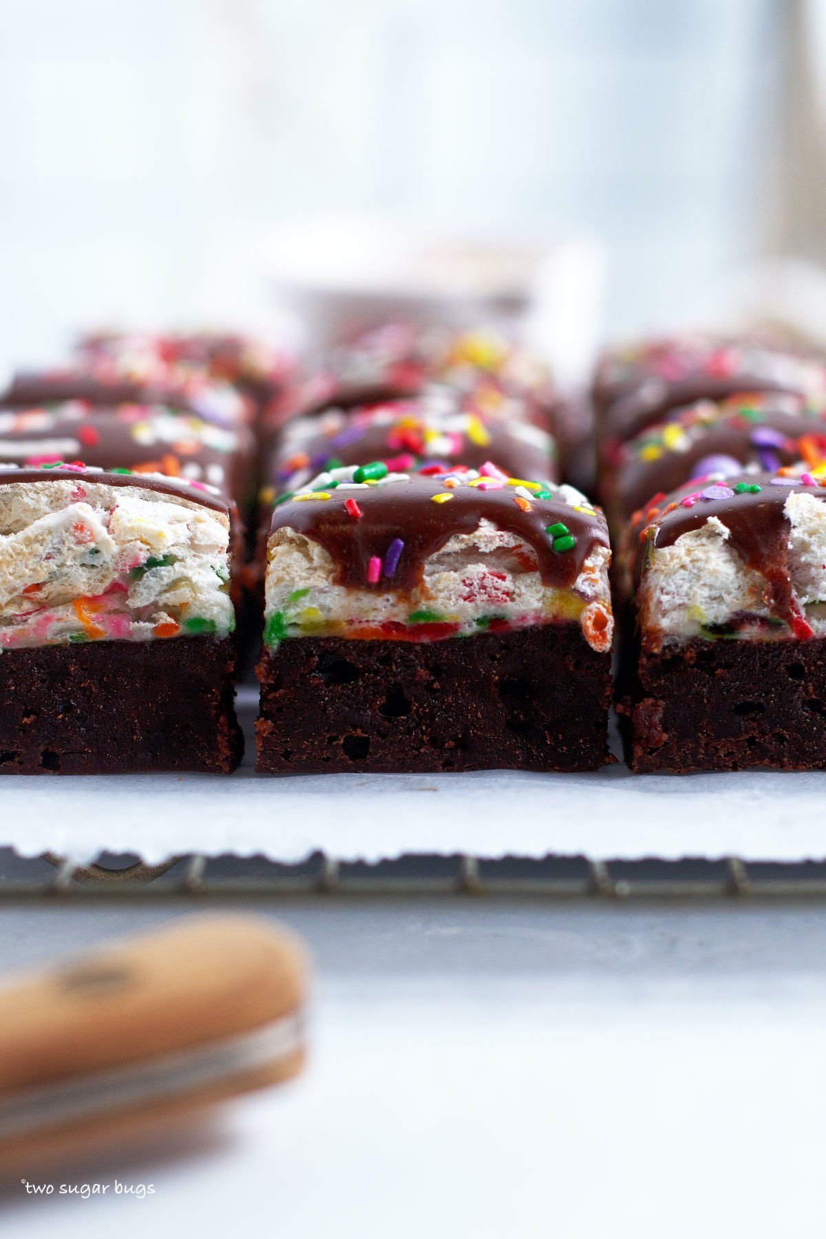 funfetti brownies on a parchment lined cooling rack