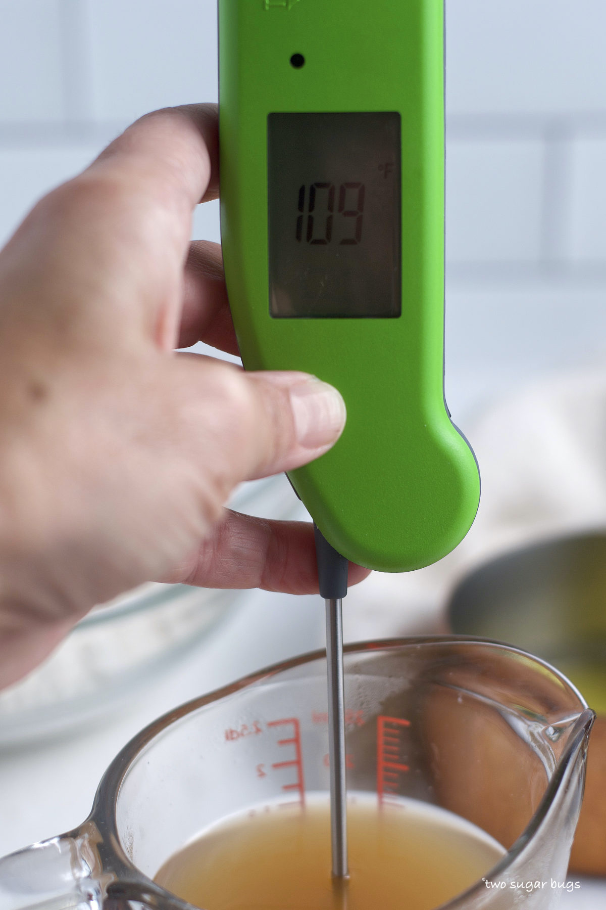 instant read thermometer checking apple cider temperature