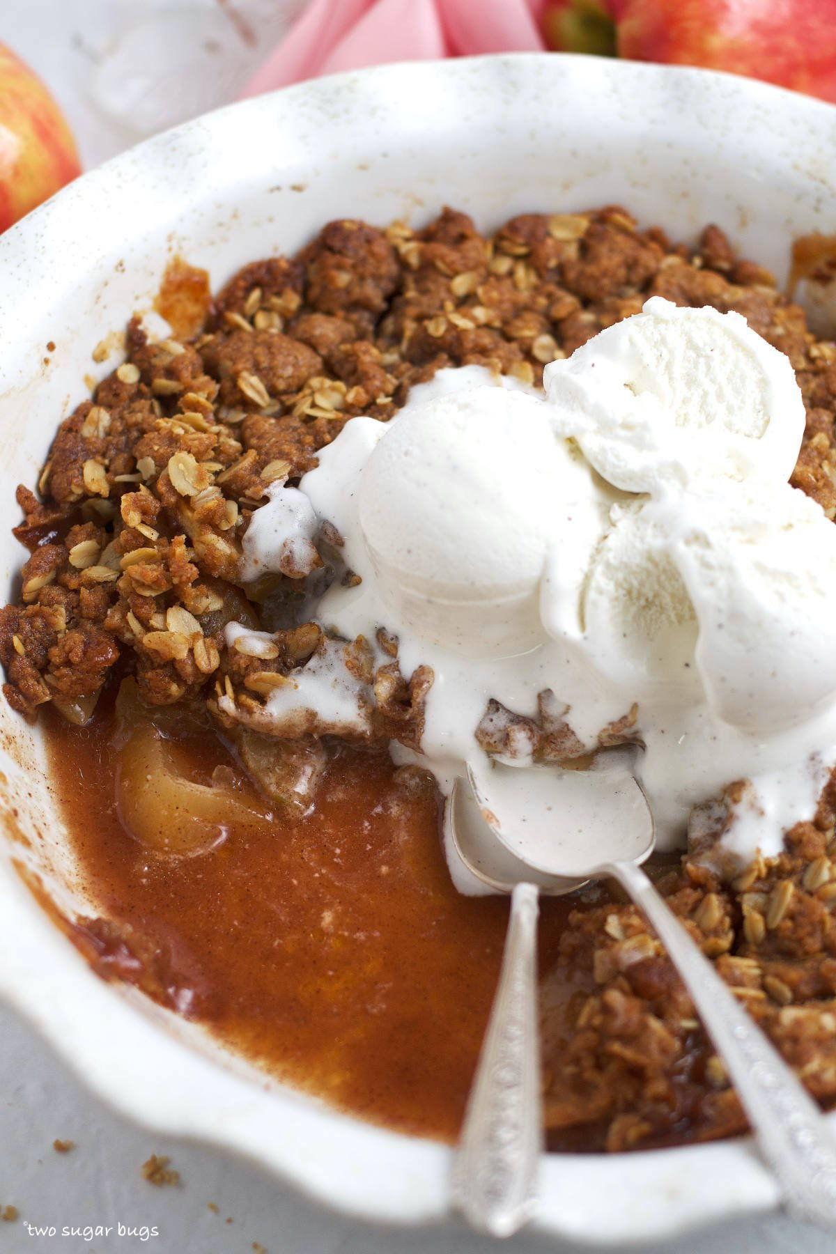bourbon apple crisp with ice cream and two spoons