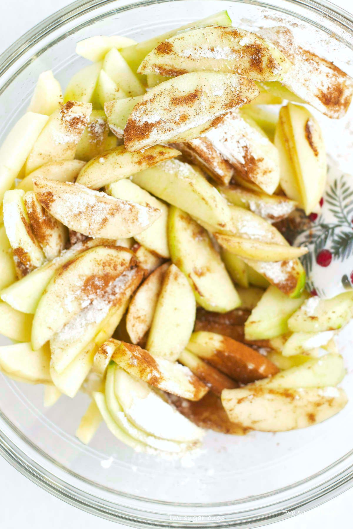 apples with flour, cinnamon and brown sugar in a bowl