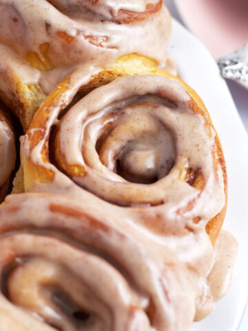 apple cider cinnamon rolls after they've been baked and glazed