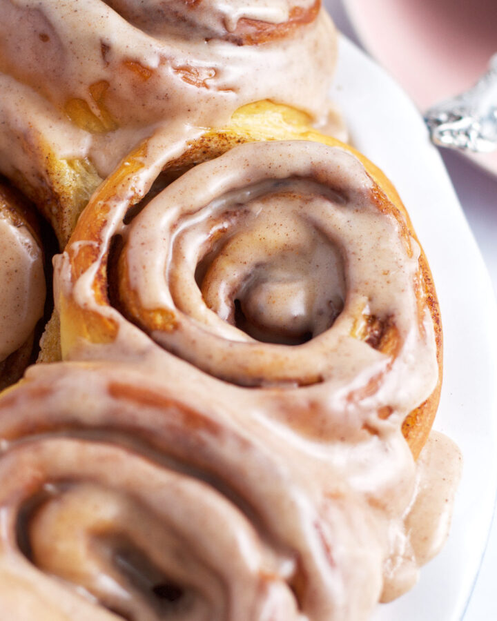 apple cider cinnamon rolls after they've been baked and glazed
