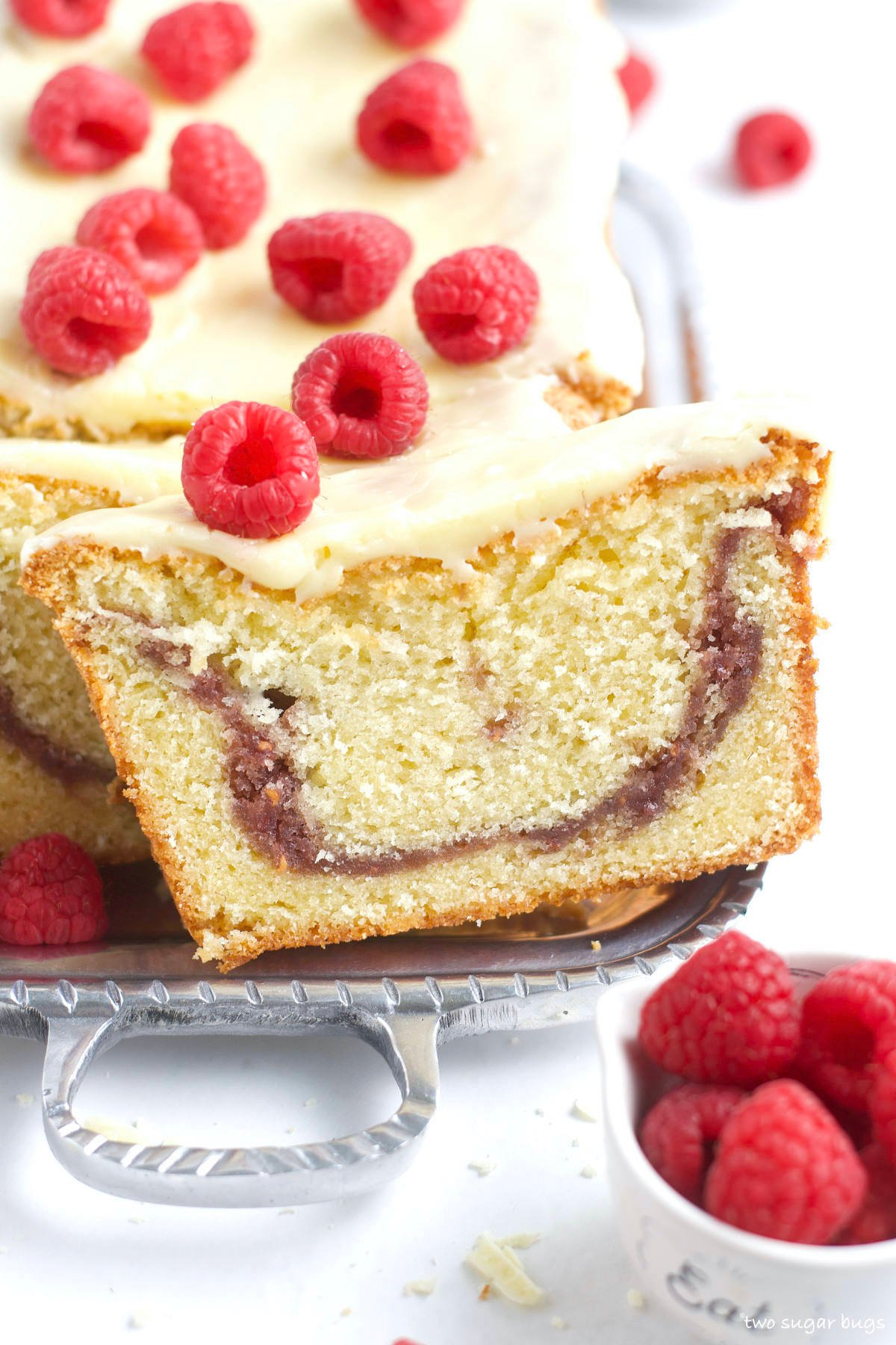 cut slice of cake with fresh raspberries on top