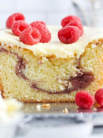 raspberry white chocolate loaf cake on a serving plate