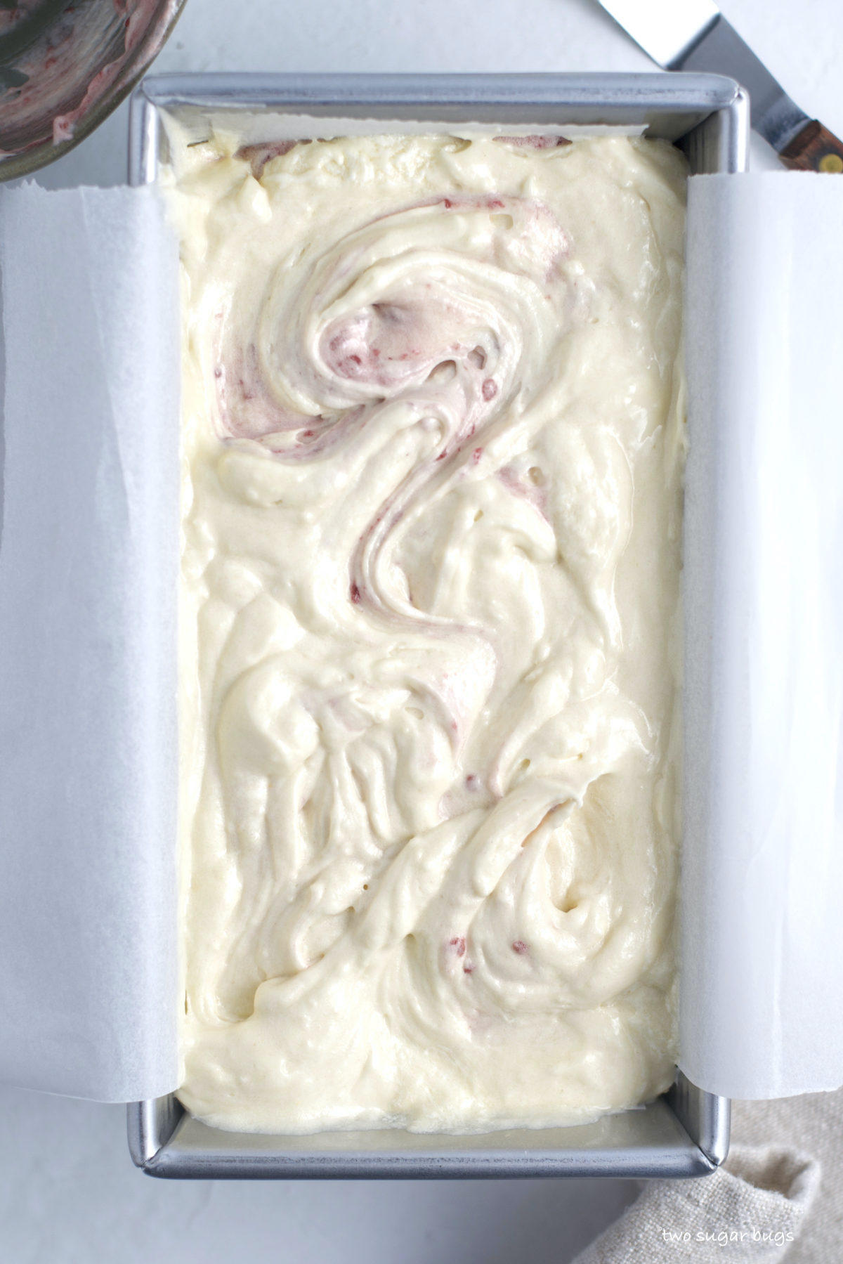raspberry white chocolate cake batter swirled together in the baking pan