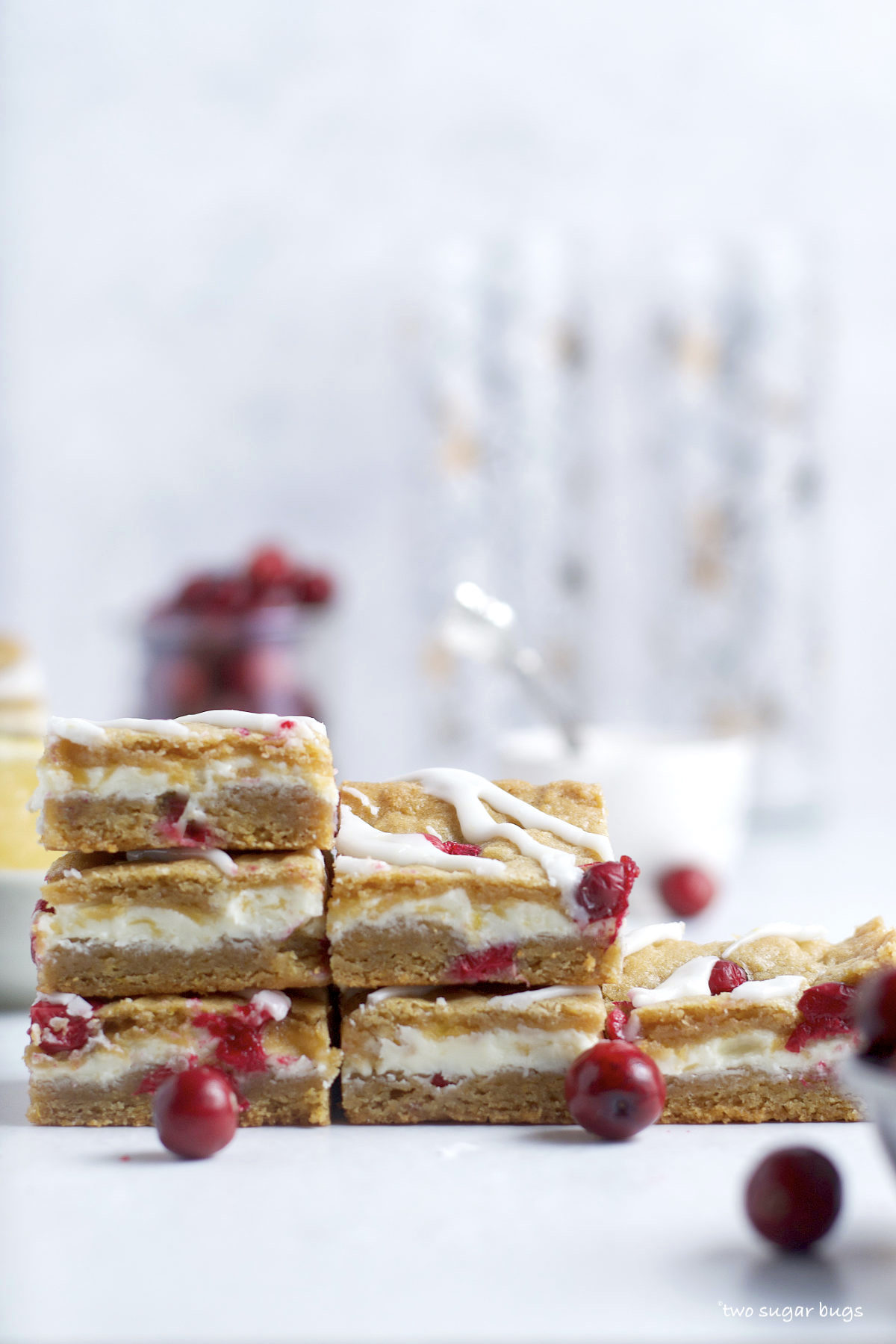 pile of lemon cranberry bars with fresh cranberries
