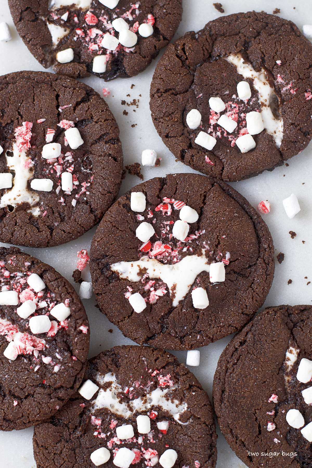hot cocoa cookies on a countertop with cookie crumbs