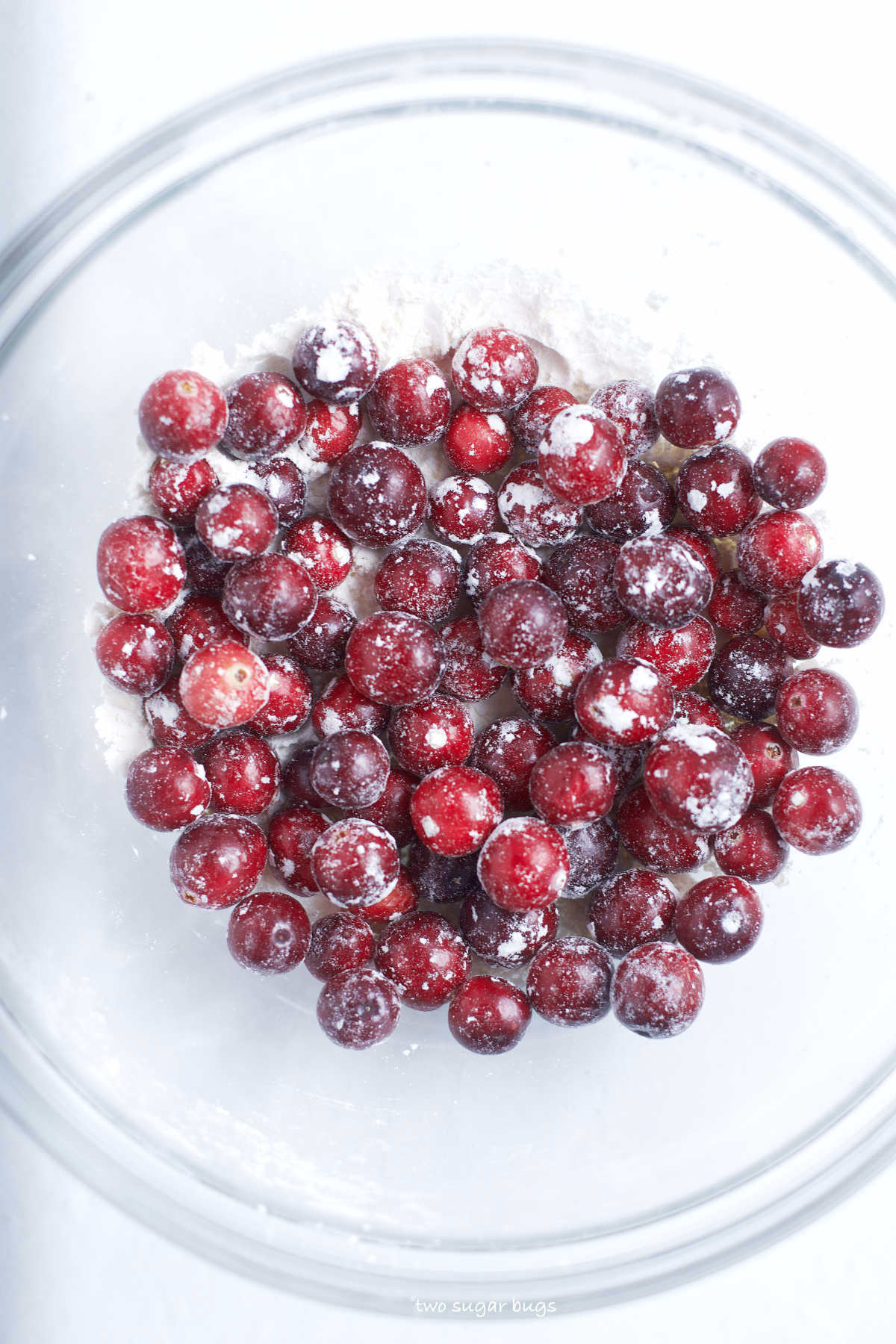 fresh cranberries tossed with flour in a bowl