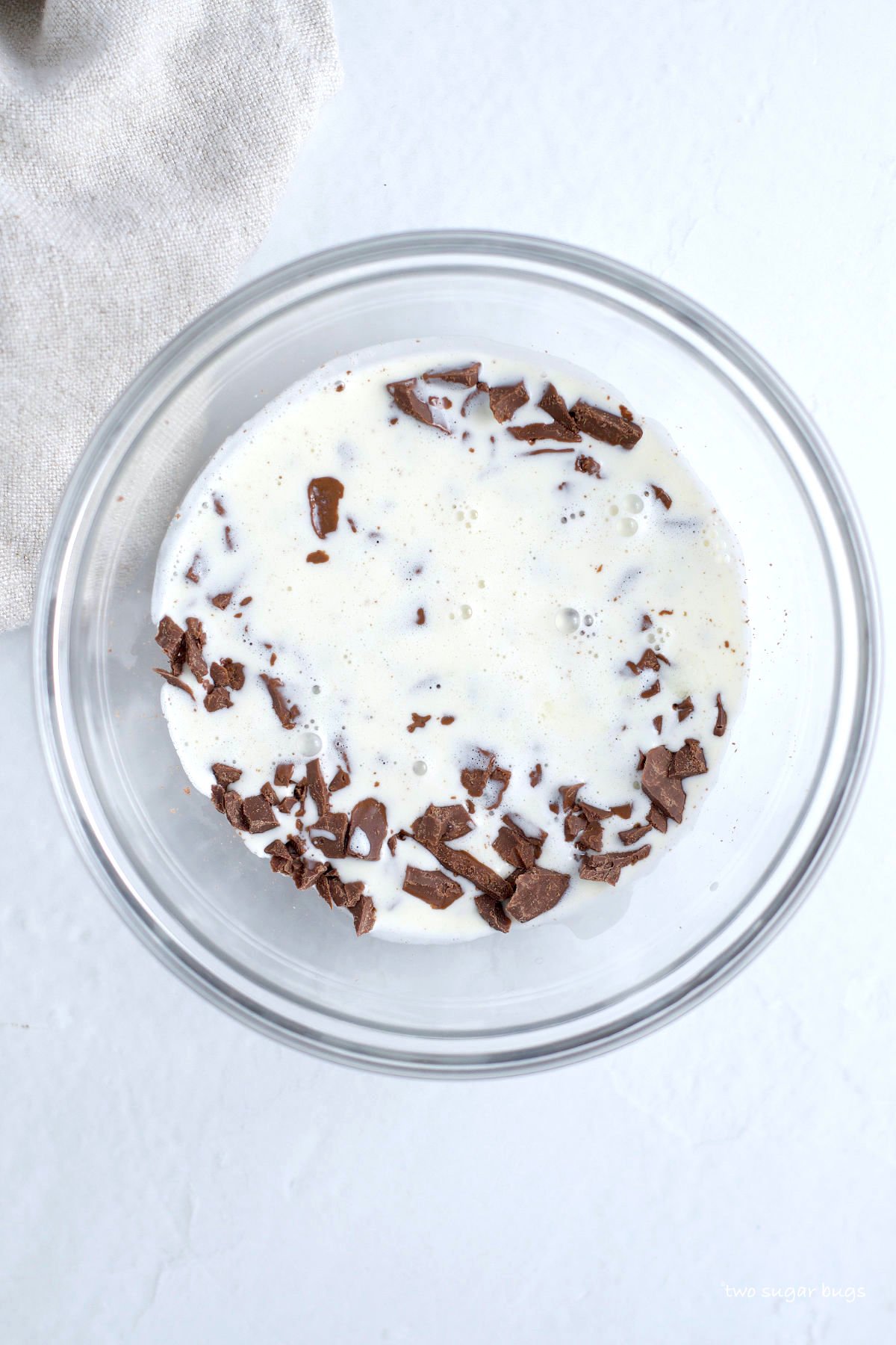 chopped chocolate and heavy cream in a bowl