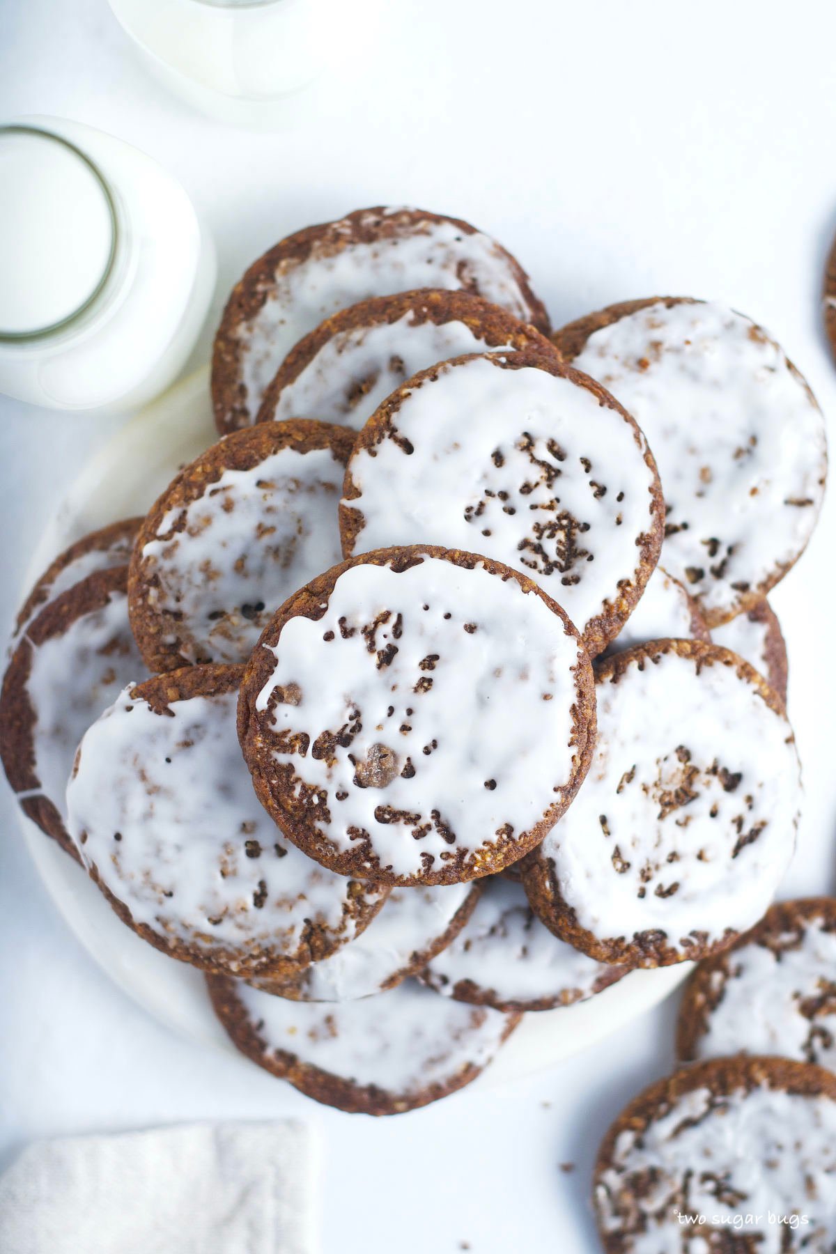 pile of iced molasses cookies with milk