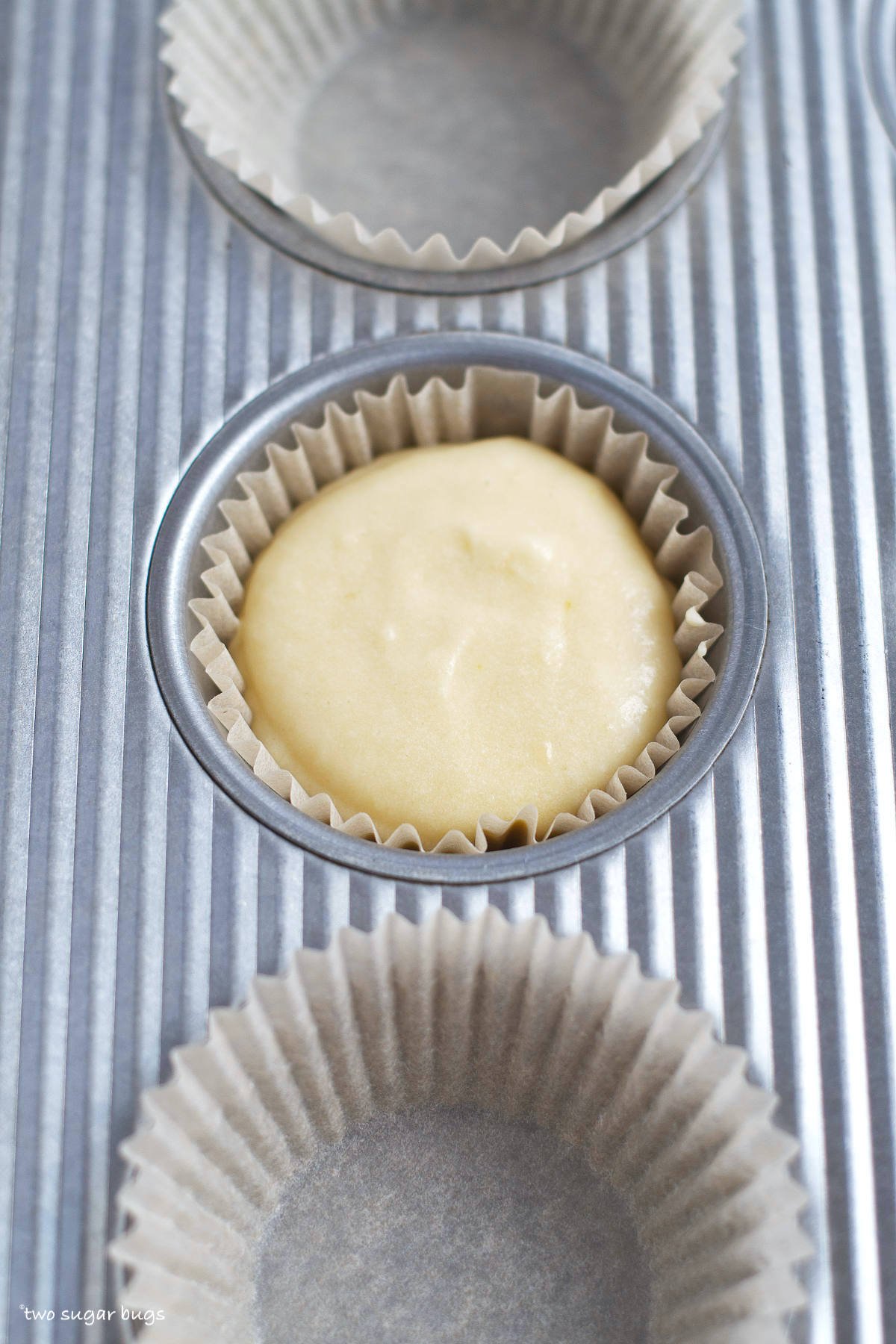 cupcake batter in a lined muffin tin