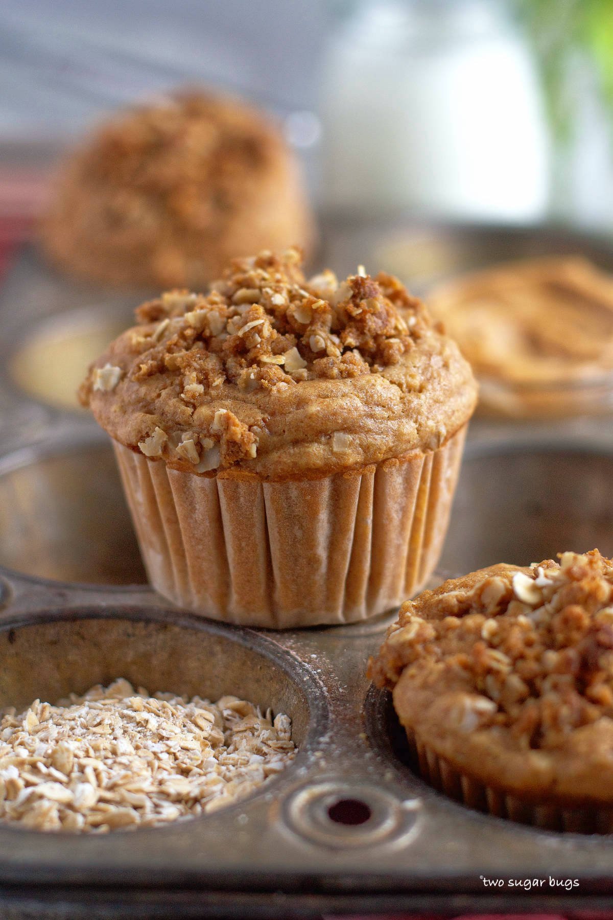 peanut butter muffin with peanut butter streusel sitting on a muffin pan