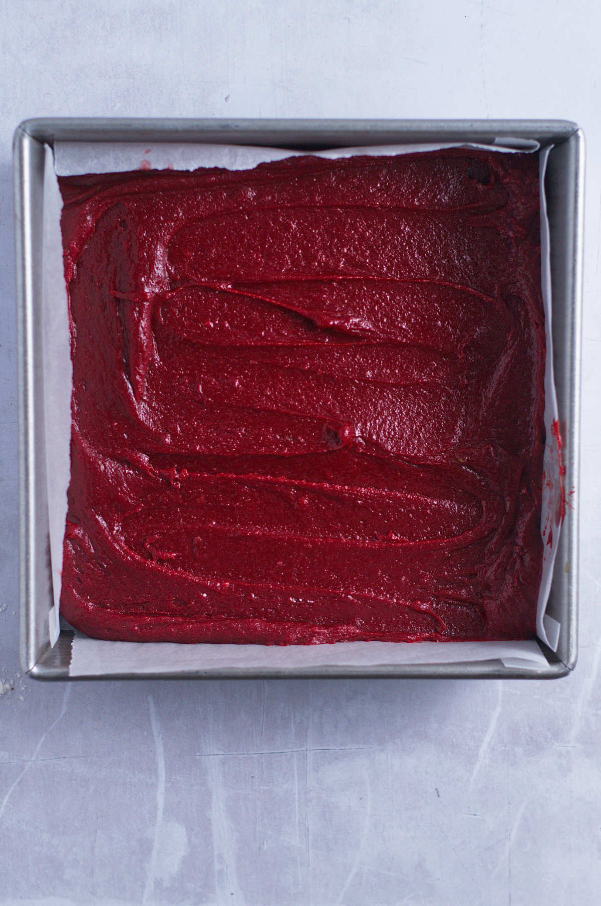 red velvet brownie batter in a baking pan