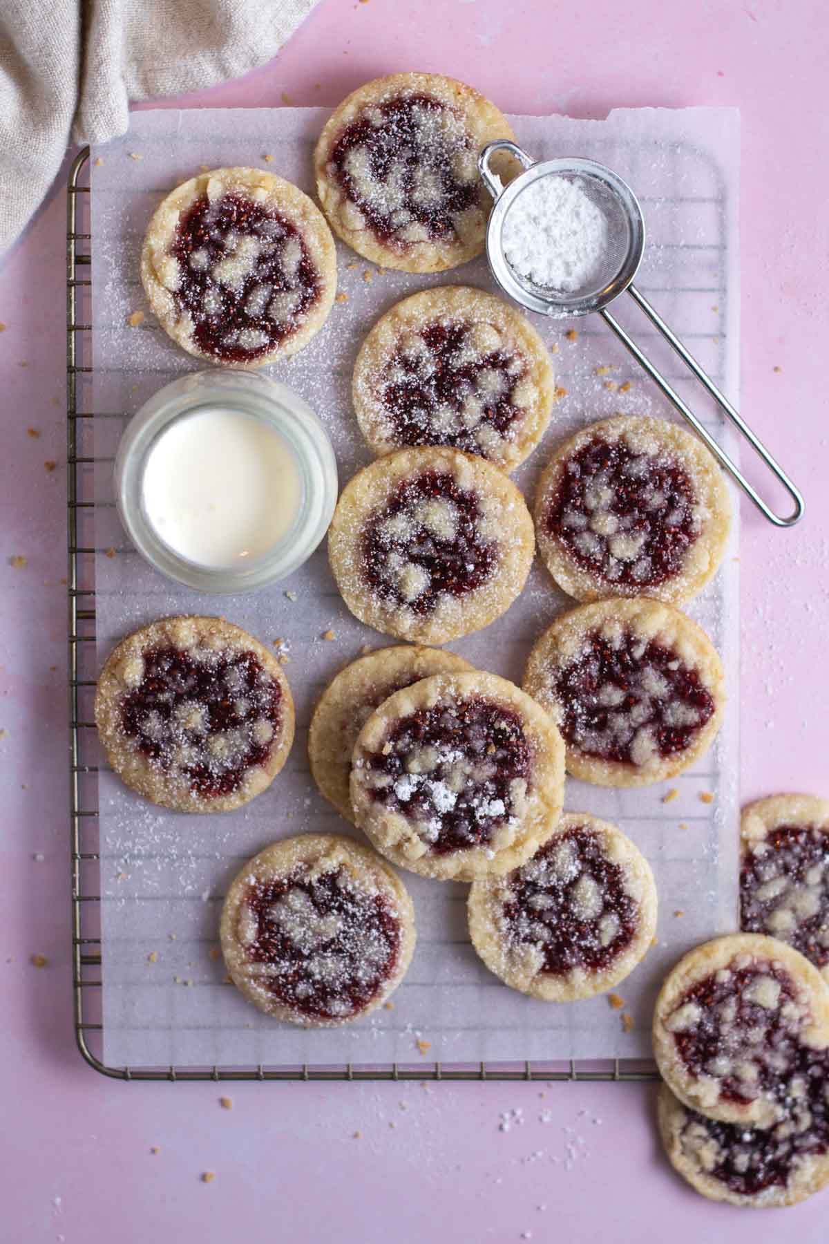 raspberry crumble cookies on a parchment lined cooling rack
