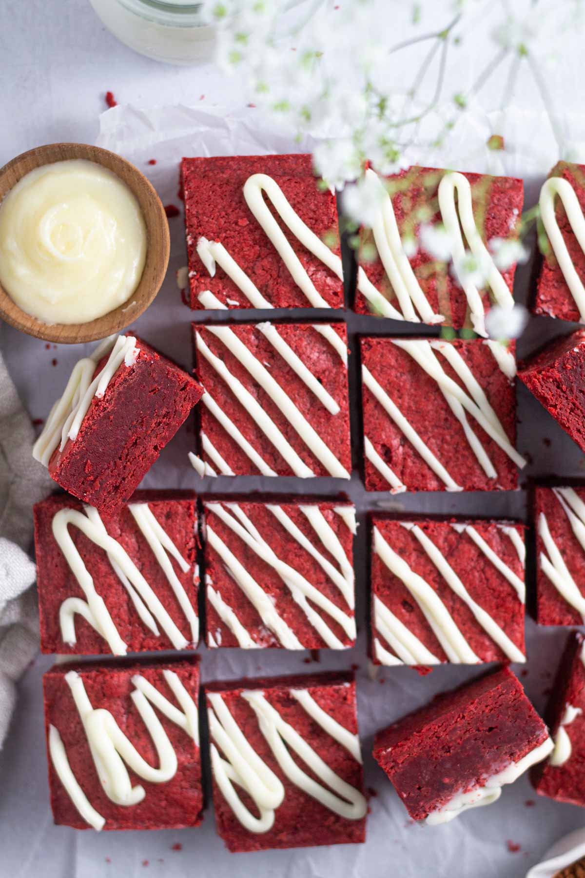 red velvet brownies with a bowl of cream cheese icing