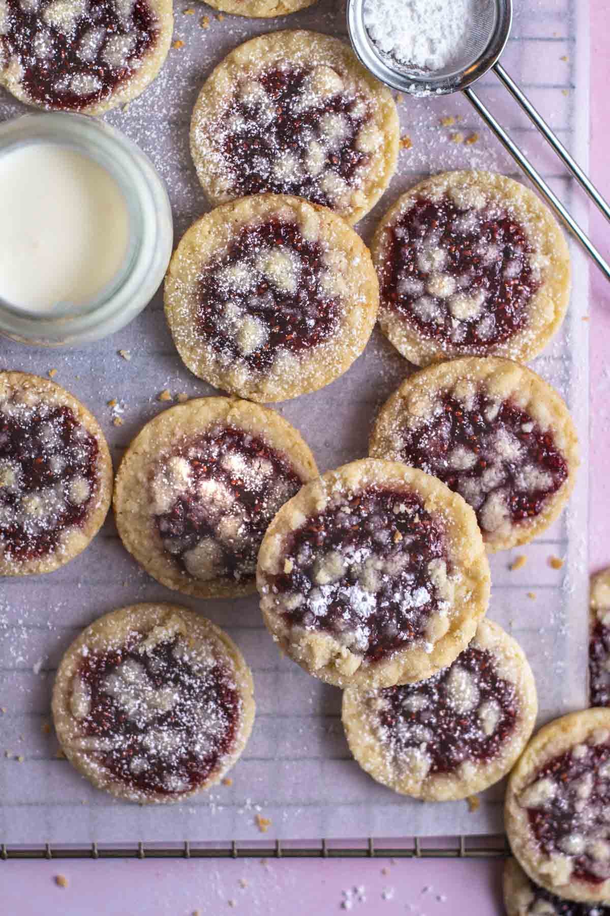 cookies on a cooling rack with milk and confectioners' sugar