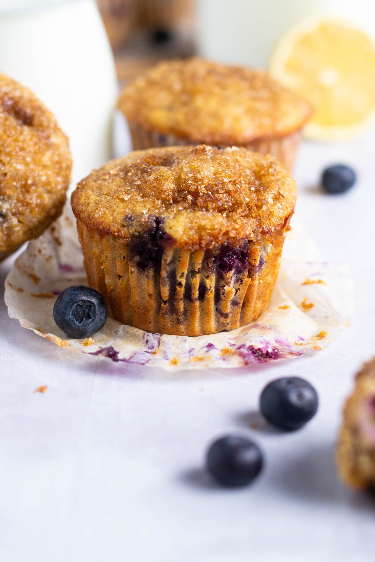 lemon blueberry muffin with the liner pulled off