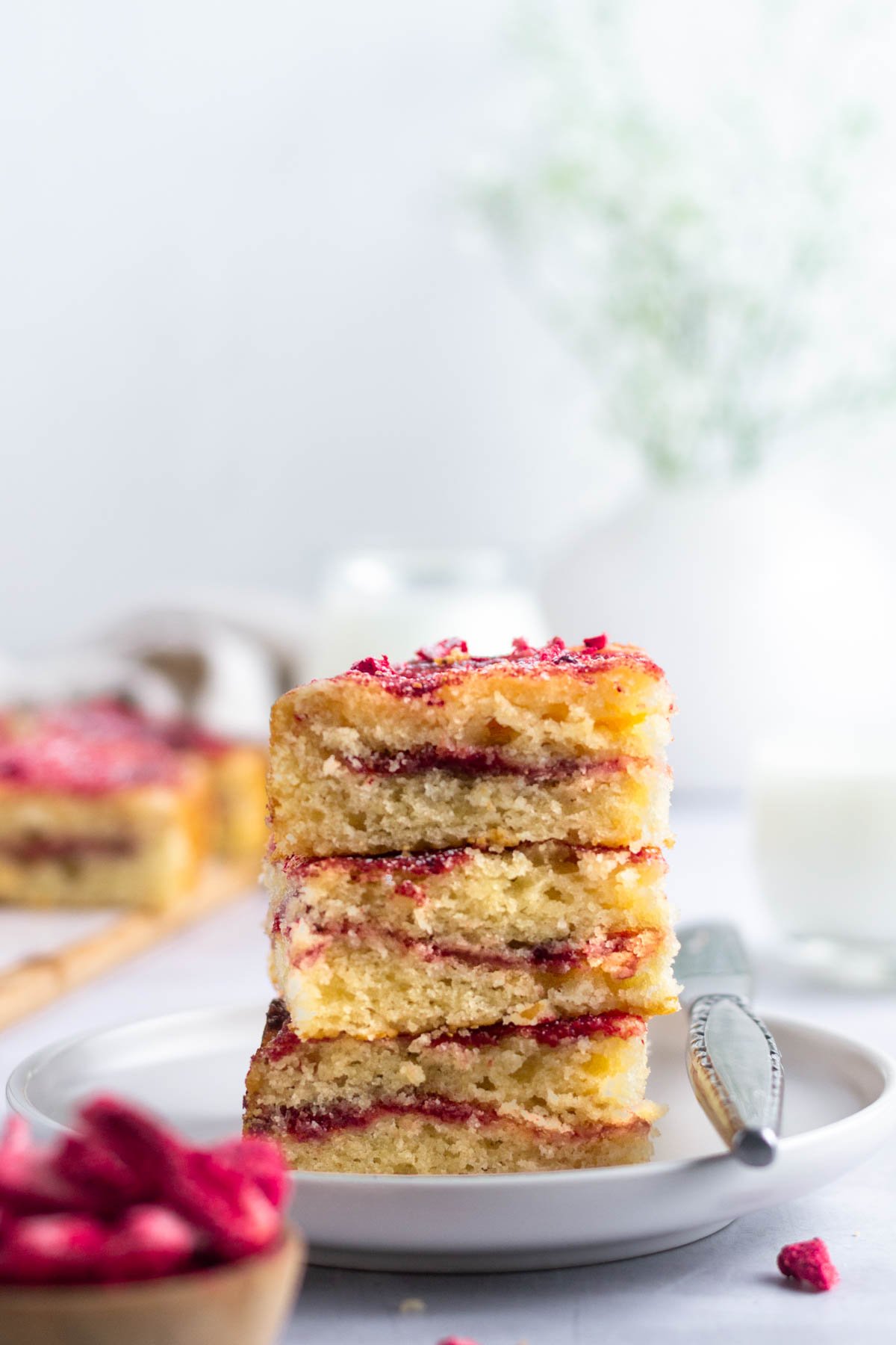 stack of three slices of strawberry crumb cake on a plate