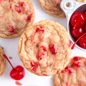 cherry almond cookies with a cup of maraschino cherries