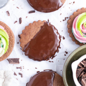chocolate cut out cookies dipped in chocolate and decorated with buttercream