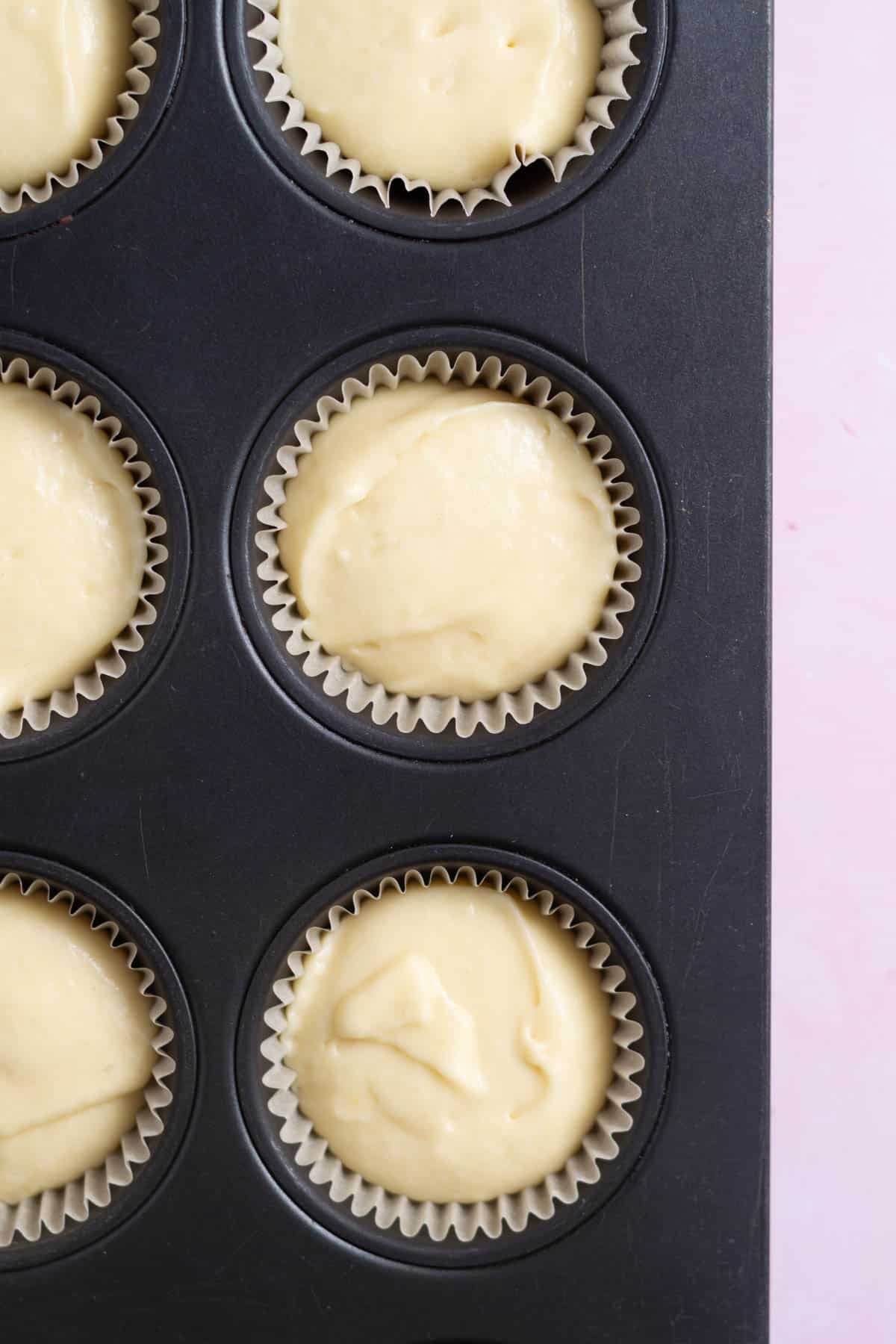 vanilla cupcake batter in cupcake liners