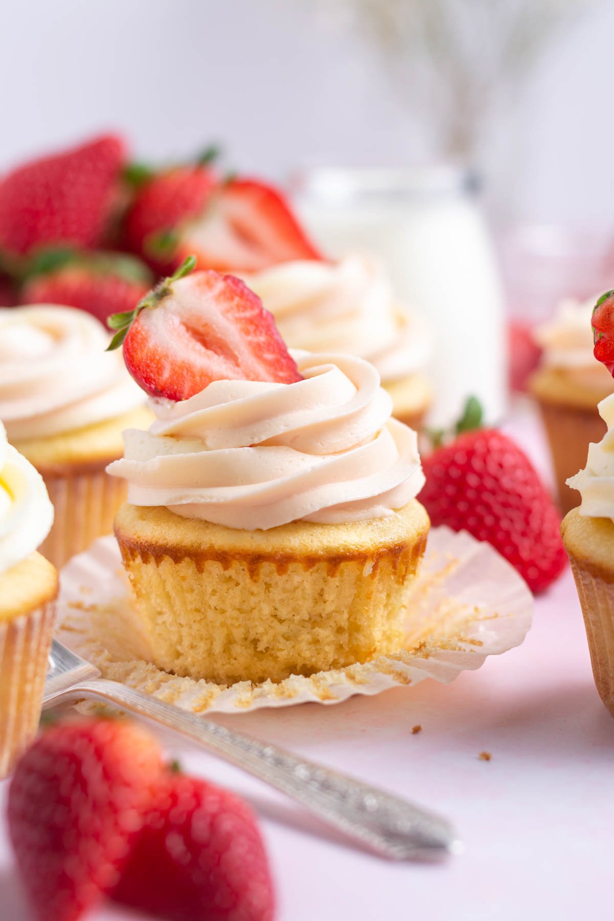 Strawberry filled cupcakes with fresh strawberries.