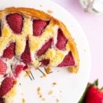 top view of strawberry vanilla cake with a couple slices missing