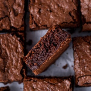 Almond flour brownie on it's side showing fudgy middle