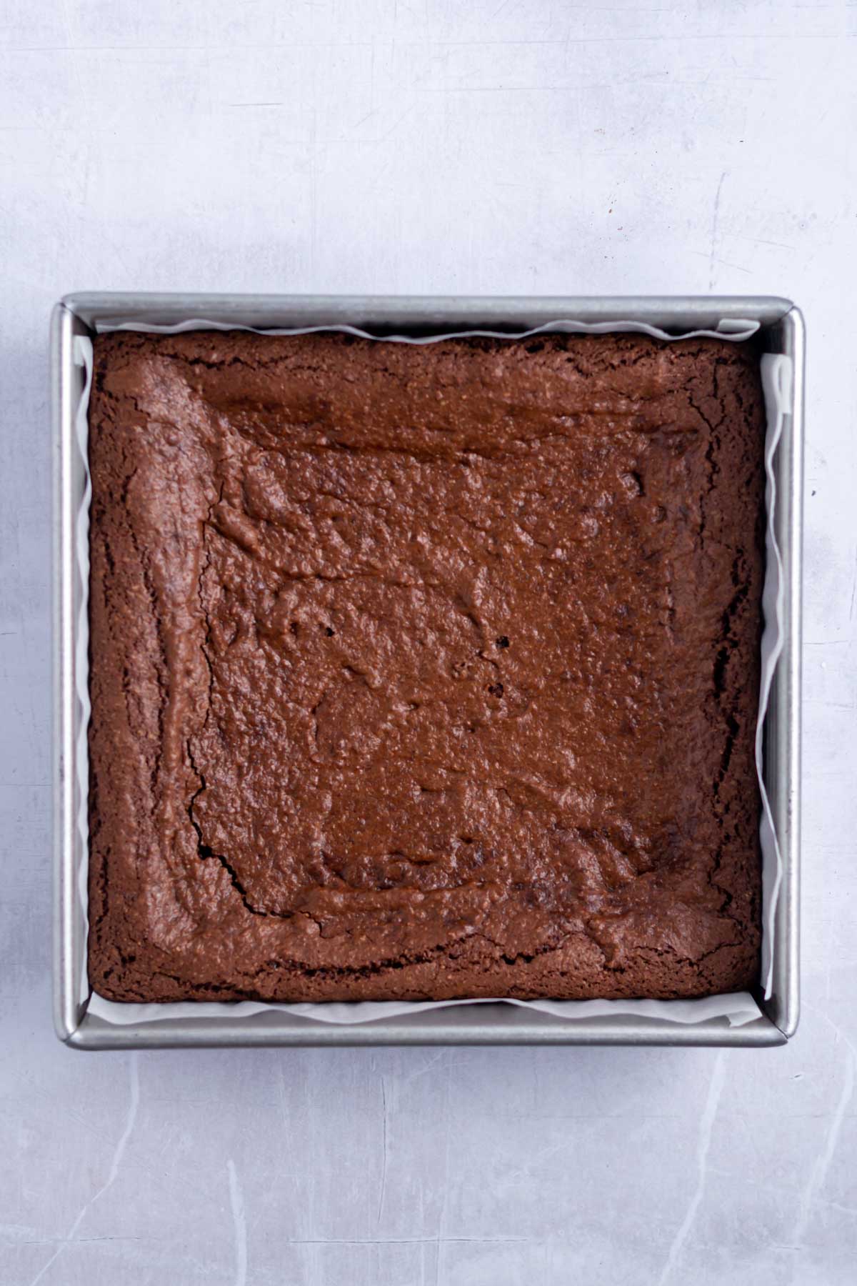 Baked gluten free brownies in a baking pan.