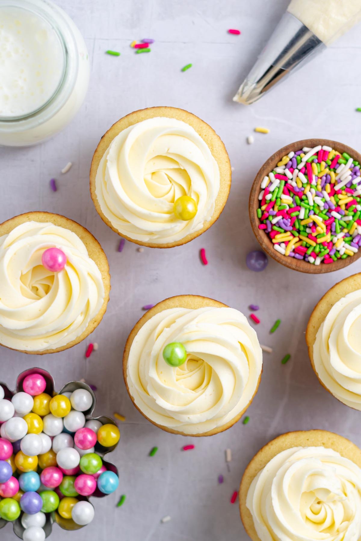 vanilla buttercream swirls atop cupcakes